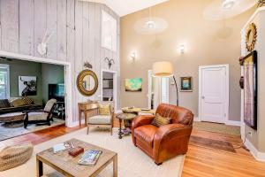 a living room with a leather couch and a table at Garden Home in Austin