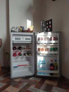 an empty refrigerator with its door open in a kitchen at Hotel Cesar´s in Lima