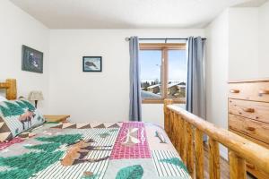 a bedroom with a bed and a window at The Moose Crossing in Anchorage