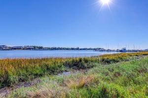 a body of water with the sun in the sky at Mariners Cay 23 in Folly Beach