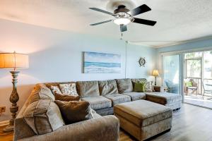 a living room with a couch and a ceiling fan at Mariners Cay 23 in Folly Beach