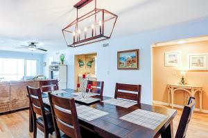 a dining room and living room with a table and chairs at Mariners Cay 23 in Folly Beach