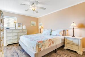 a bedroom with a bed and a ceiling fan at Sand Dollar Villas 109 in Fernandina Beach