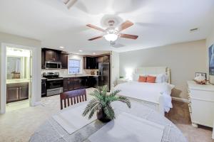 a bedroom with a bed and a ceiling fan at Southern Charm Getaway in Charleston