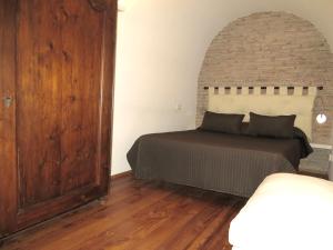Giường trong phòng chung tại Appartamento Benincampi