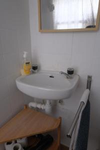 a white sink in a bathroom with a mirror at Beco das Canas Apartment in Lisbon