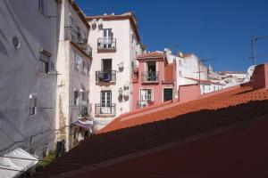 a group of buildings with red tile roofs at Beco das Canas Apartment in Lisbon