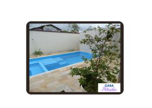 a picture of a swimming pool in a house at Casa Peruibe. in Peruíbe