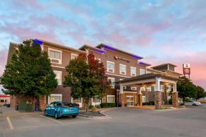 a hotel with a car parked in a parking lot at Best Western Plus Butterfield Inn in Hays