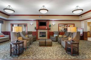 a hotel lobby with couches and a fireplace at Best Western Plus Butterfield Inn in Hays