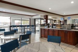 a kitchen and dining room with a table and chairs at Best Western Edinburgh/Columbus in Edinburgh