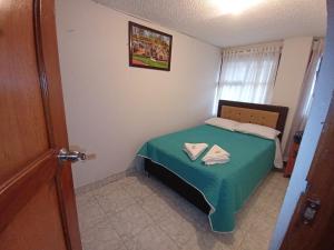 Postel nebo postele na pokoji v ubytování Hospedaje Los Cedros- Monguí