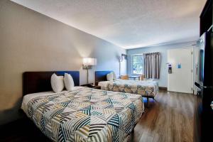 a hotel room with two beds and a window at Motel 6 Birmingham, AL - Medical Center in Birmingham