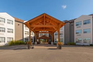 una gran estructura de madera frente a un edificio en Best Western Plus Rose City Suites, en Welland