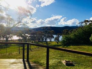 a view of a lake from a wooden deck at Beulah by the Lake in Kalkite