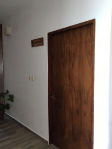 a wooden door in the corner of a room at Hotel Pelecanus Suites Holbox in Holbox Island