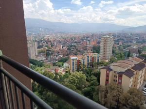 a view of a city from a balcony at Apartamento con vistas a la ciudad (Penthouse) cerca al Estadio, al Boulevard de la 70 y la Avenida 80 (Casinos, restaurantes, malls y otros). in Medellín