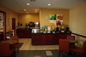 a restaurant with two tables and a counter at Quality Inn & Suites Wichita Falls I-44 in Wichita Falls