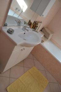 a bathroom with a sink and a mirror and a tub at Casa Elisa in Pietramurata