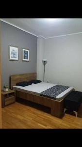 a bedroom with a large bed and a table at Piraeus historical center in Piraeus
