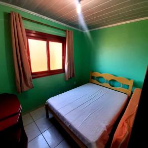 Cama o camas de una habitación en Residencial família Milani 30 metros do mar Torres
