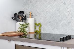 a kitchen counter with two white vases and utensils at Heritage 103 in Tuncurry