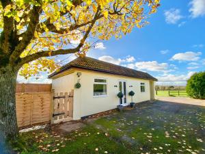 a house with a garage and a fence at The Home Stables in Southwick