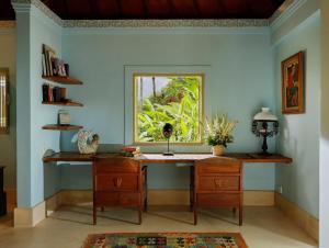 a home office with a desk and a window at Villa Inka Ubud by Nakula in Ubud