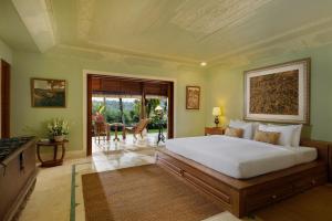 a bedroom with a large bed in a room at Villa Inka Ubud by Nakula in Ubud