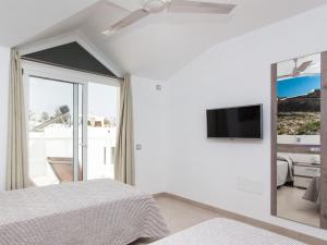 a bedroom with two beds and a mirror at Resort, Corralejo in Corralejo