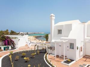 a white house with a view of the ocean at Resort, Corralejo in Corralejo