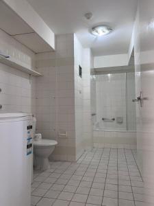 a bathroom with a toilet, sink, and bathtub at Condor Ocean View Apartments Surfers Paradise in Gold Coast