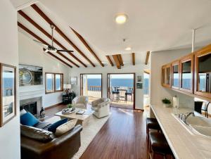 a kitchen and living room with a view of the ocean at Premium Ocean Corner Unit, Fireplace, Golf Cart, 21 Steps from Top in Avalon