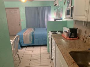 Una pequeña cocina con una cama en una habitación en Michaels Surfside Cabanas, en Clearwater Beach