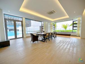a dining room with a table and chairs in a building at Bali Sea View Residences Melaka at Stayrene in Melaka