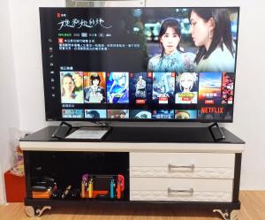 a flat screen tv sitting on top of a dresser at 古堡民宿-電動麻將 l switch l 依人數開客房 l 預訂後請加Line in Tainan