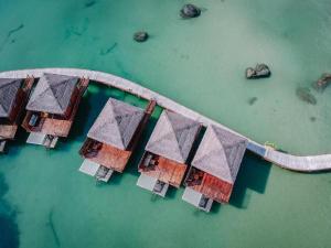 an aerial view of a group of houses in the water at Rocks Beach Boutique in Phú Quốc