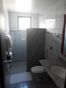a bathroom with a toilet and a sink at Alpes Hotel in Venda Nova do Imigrante