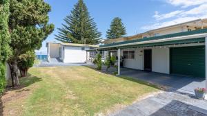 an empty yard in front of a house at Absolute Beach in Callala Beach +23 photos