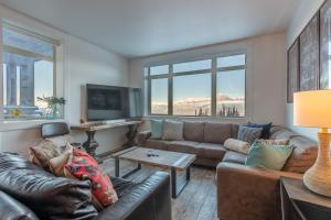 a living room with a couch and a table at Fully Renovated Ski-in/out Loft with Private Hot Tub! in Golden