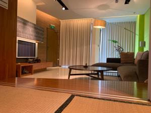 a living room with a couch and a coffee table at Tainan Anping - Shuiau 180 in Tainan