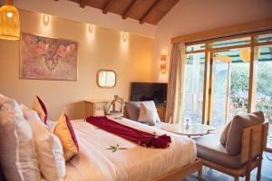 a hotel room with a large bed and a patio at Wild Rose Resort and Spa in Pushkar