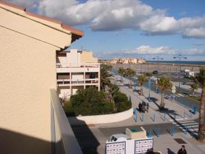 a view from a balcony of a building and a street at IBIS in Saint Pierre La Mer