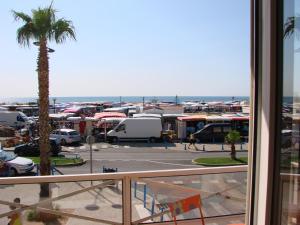 a view of a parking lot with a palm tree at IBIS in Saint Pierre La Mer +7 photos