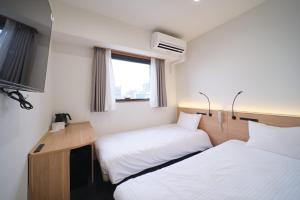 Postel nebo postele na pokoji v ubytování Ano Hotel Asakusa