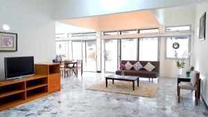 a living room with a couch and a tv at Advent Villa, Penang - Near Adventist Hospital in George Town
