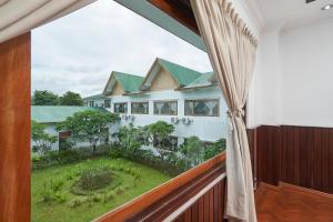 a balcony with a view of a house at KMA 115 MILES Hotel in Pyu