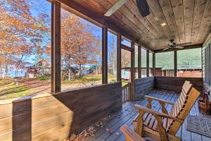 a screened in porch with two chairs and a table at Inviting Webb Lake Cabin with Mountain Views 
