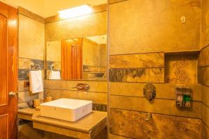 un bagno con lavandino e specchio di Cottage On The Lake by VEO - Part of StayVista a Bhimtal Altre 19 foto