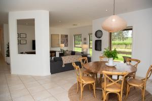 a dining room and living room with a table and chairs at Triple Creek Guest House - Barossa Region in Seppeltsfield